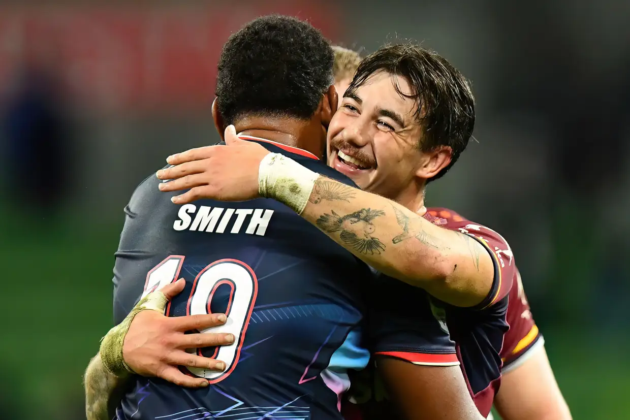 Connor Garden-Bachop of the Highlanders and Angelo Smith of the Rebels hug. Getty