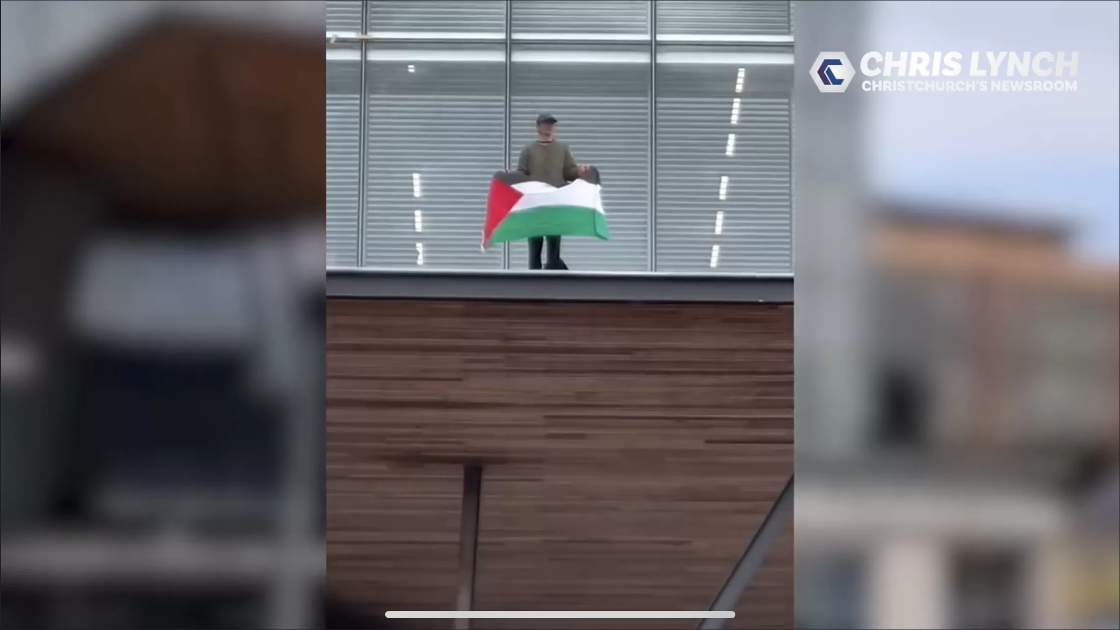 Lone protestor climbs onto council building